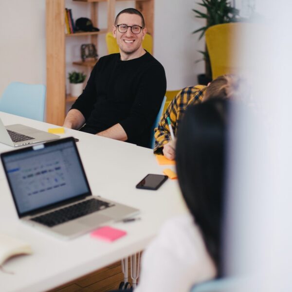 Photo by Jason Goodman smiling man beside writing person